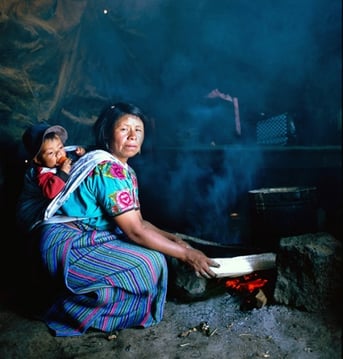 A woman tends an open fire in Guatemala