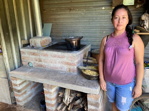 A woman in El Salvador receives a stove